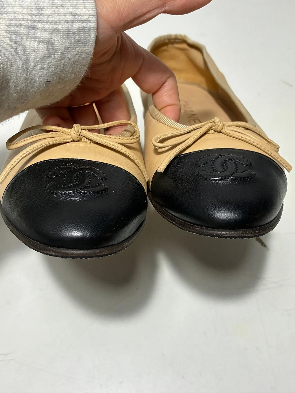 CHANEL Beige Leather Ballet Flats with Black Cap Toe and CC Logo